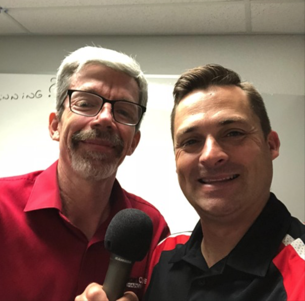 Earl Blood and Chad Jordan holding a microphone